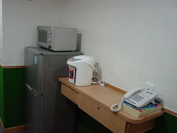 Public fridge and water kettle.