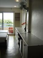 Fridge, wall fan and large cupboard inside River Breeze room.