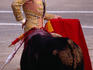 Matador draws bull in with cape to prepare fatal blow with espada (sword).