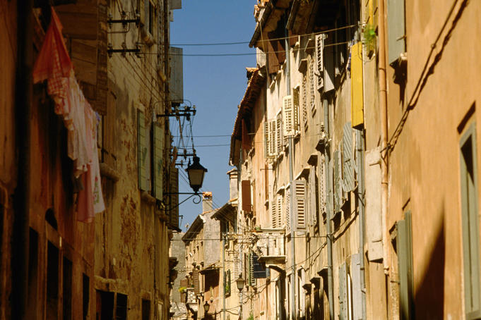 Building facades in winding cobbled street of fishing town.