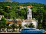 Buildings and cruise ship in harbour of resort town.