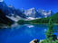 The impossibly blue waters of Moraine Lake, surrounded by the Rocky Mountains in the Banff National Park.
