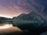 Mountain by a lake at sunset.