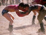Men wrestling in traditional costume during the Naadam Festival.