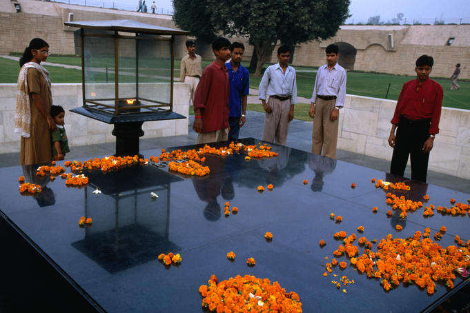 Commemorative place of Mahatma Ghandi's cremation in Delhi. The large black slab of Raj Ghat is strewn with symbolic marigolds.