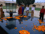 Commemorative place of Mahatma Ghandi's cremation in Delhi. The large black slab of Raj Ghat is strewn with symbolic marigolds.
