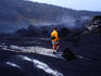 A woman hiking the Kilauea Iki Crater in the Hawaii Volcanos National Park.