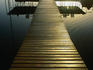 A sunlit wooden pier in the Lamanai Lagoon.