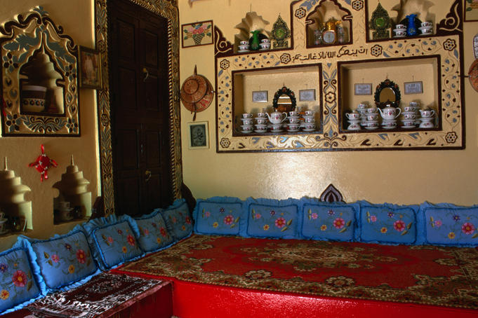 Inside an Harari home with decorative items on the wall and small niches for domestic crockery.