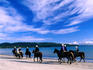 Horse riding along the beach.