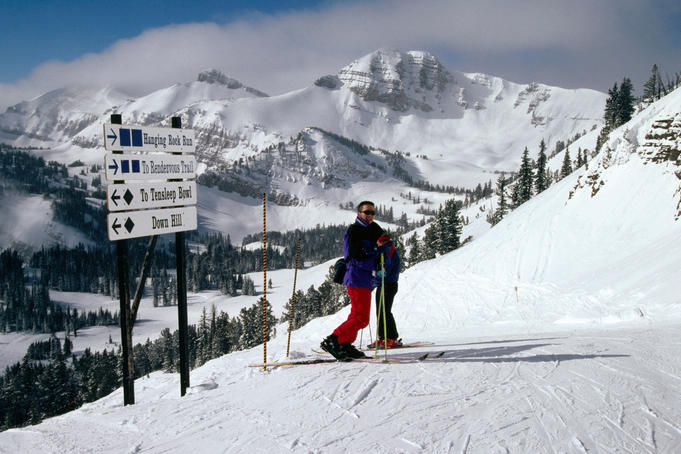 Ski run and sign on Rendezvous Peak in Teton Range of Rocky Mountains.