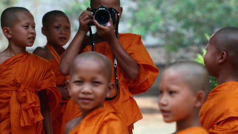 Novice monks learning workings of camera.