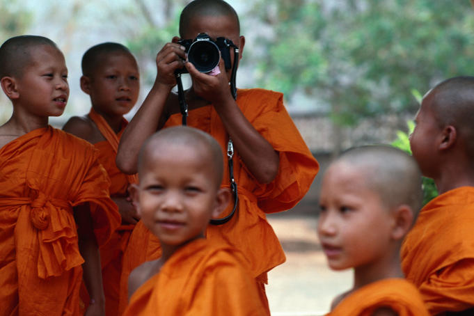 Novice monks learning workings of camera.