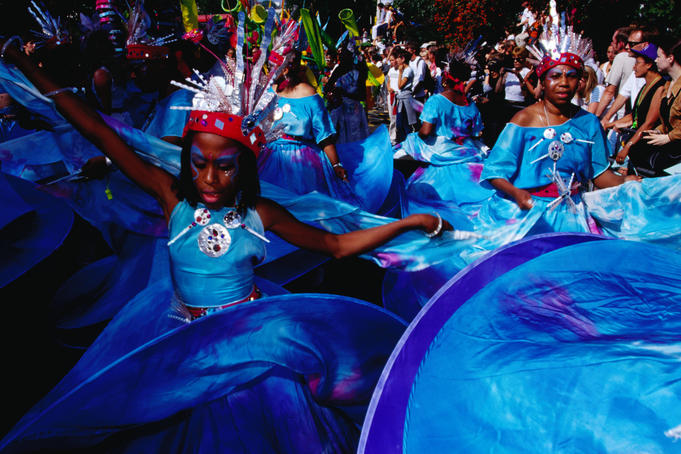 People in costume dancing at Notting Hill Gates annual carnival.