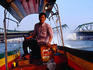 Driver on long tail boat on the Chao Phraya (River).