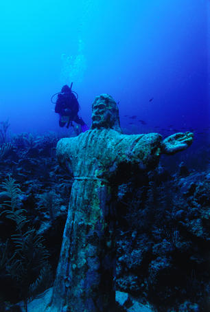 Statue of Christ on reef underwater.