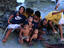 Group of children playing on shore.