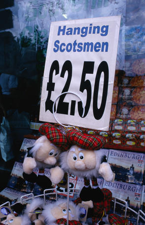 Souvenirs in shop window, hanging Scotsman.