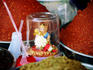 Small figurine amongst red and green curry paste.