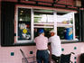 Two men in the window of a Cuban coffee shop, Miami.