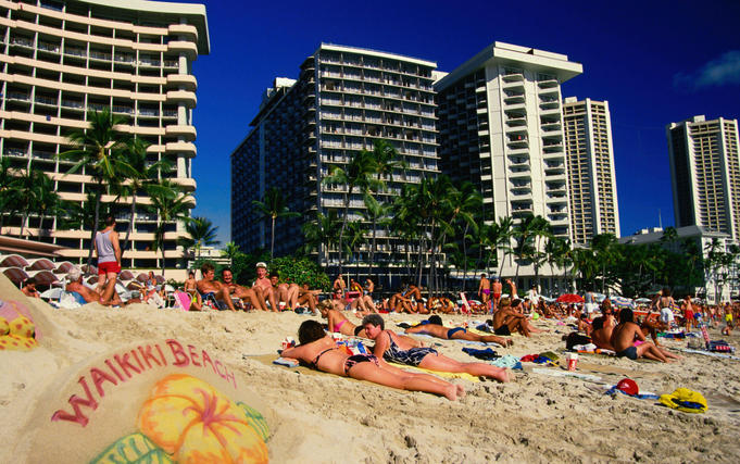 People sun baking on the beach - Waikiki, Hawaii
