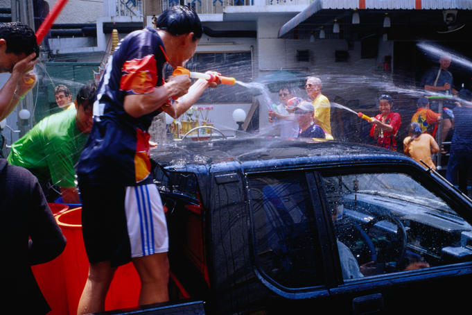 Spraying water water pistols to celebrate Thai New Year during Songkhran Festival.