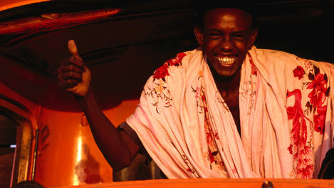 Smiling man inside truck.