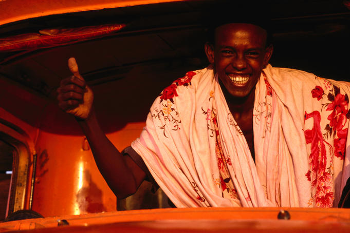 Smiling man inside truck.