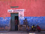 Group of boys sitting outside bar.