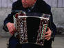 An elderly Muscovite plays the piano accordian.