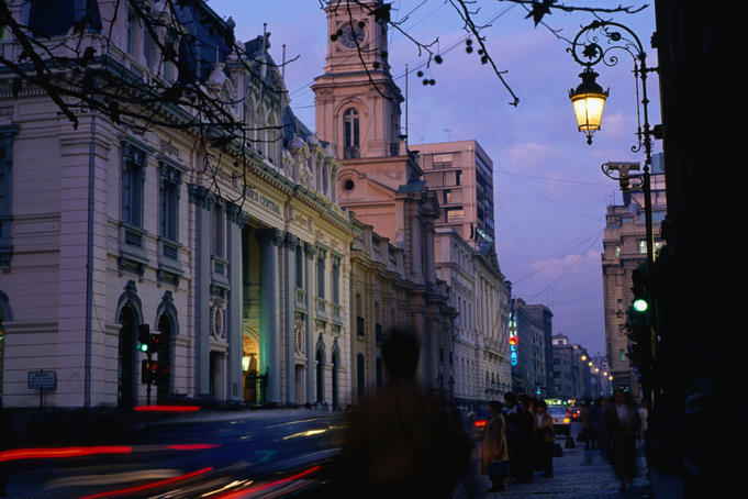 Dusk lights over traffic and Iglesia Catedral of Santiago.