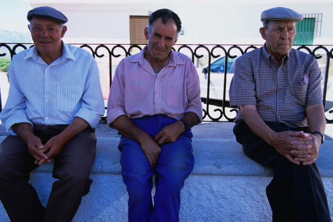 Three amigos whiling away the afternoon in the main plaza, Portugos