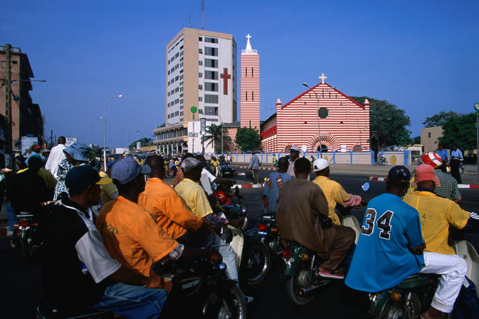 Motorbike taxis in front of cathedral.