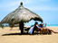 Women under beach umbrella, Benin