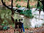 Tourists with car stuck in river, Penjari National Park.