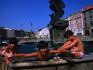 Three boys playing with water in one of the Baroque fountains in the town.