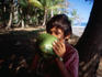 A local boy drinks coconut milk.