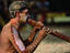 Performer playing the didgeridoo for the Mona Mona Mayi Wunba Aboriginal Dancers at the Laura Festival.