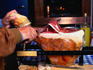 Prosciutto being carved in a home kitchen - Umbria