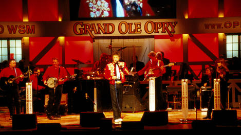 Country band playing on stage at Grand Ole Opry.