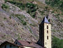 Belltower and stone buildings of a village in the Dordogne hills.