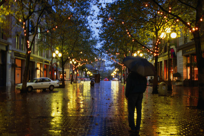 Lone figure on rainy evening in Occidental Square.