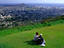 A couple relaxing on Mt Tantalus with a breath-taking view of Honolulu at Pu'u Ulaka'a State Wayside Park.