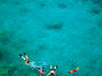 Aerial view of snorkellers swimming around Honolua Bay, a state marine conversation district.