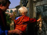 A young boy touching the St John of Nepomuk plaque (patron saint of the Czechs) on St Charles Bridge for good luck.