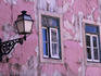 Pink paint peeling on exterior of old building in Alfama.