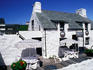 White-washed restaurant with outdoor cafe.