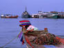 Young Thai boy sleeping on bow of fishing boat at Samui Island.