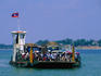 A packed ferry on the Mekong River makes its way into Pakse port