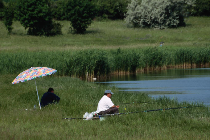 Fishermen relaxing on the banks of Inner Lake in Tihany.
